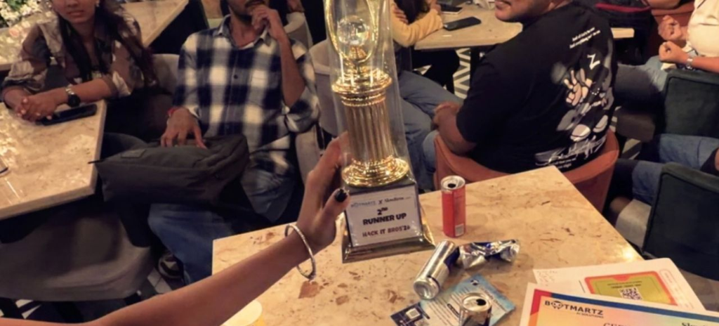 Official 2nd Runner Up golden trophy and awards table at HackItBros '26